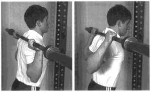 man lifting barbell behind head without weights